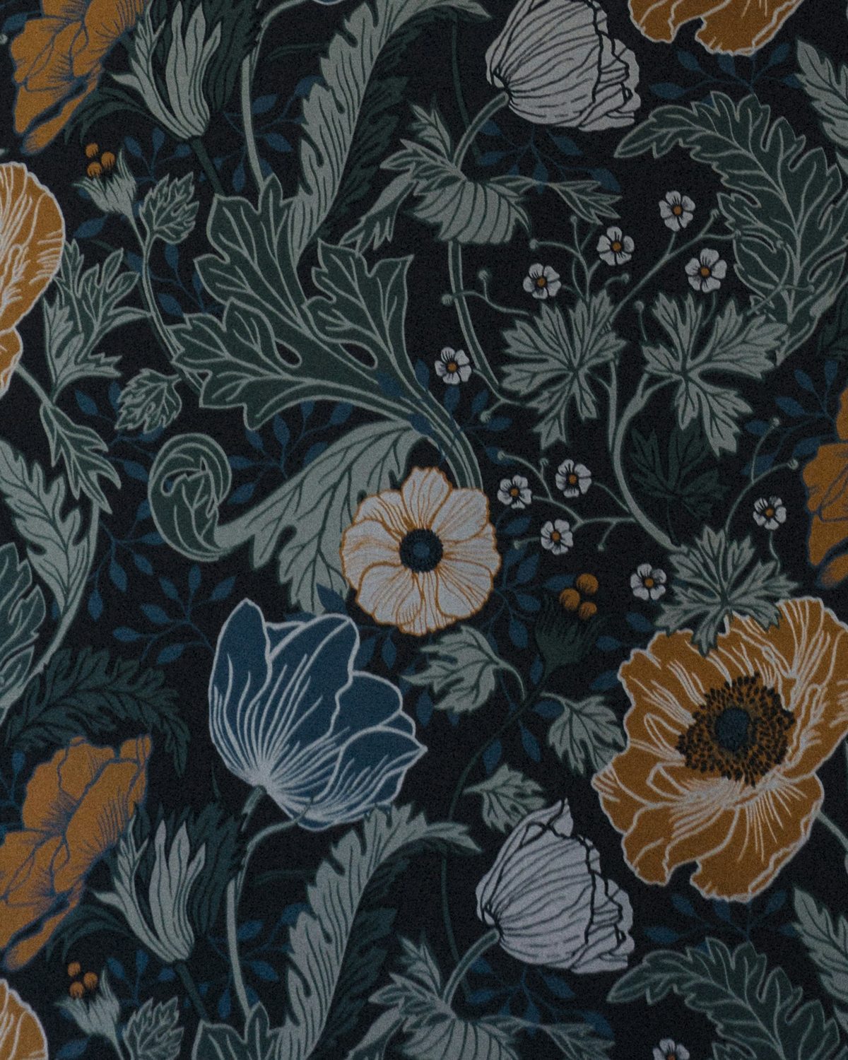 Close view of dark navy wallpaper printed with large ochre poppies, blue tulips and sage foliage